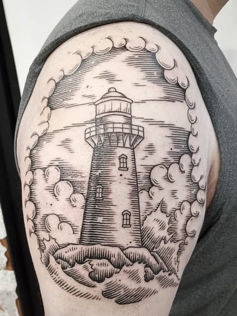 Engraving-like black linework tattoo of a lighthouse surrounded by clouds