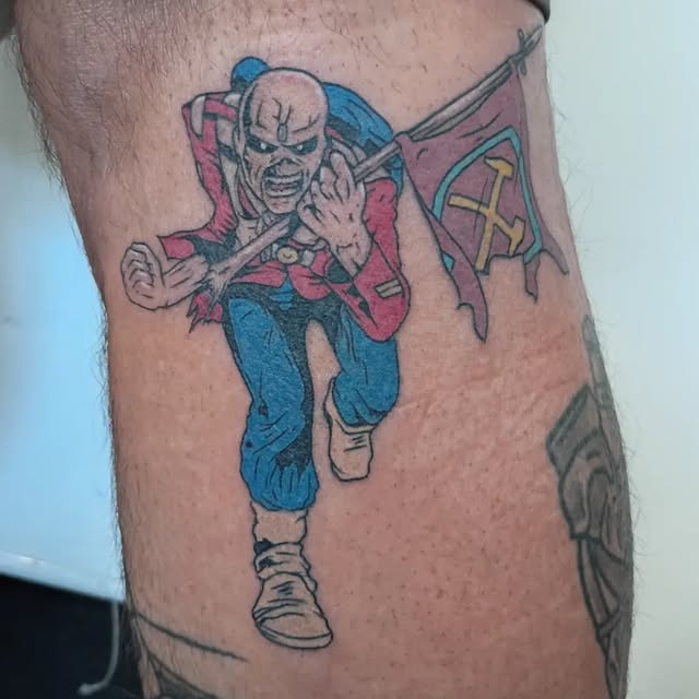 Color tattoo of a running figure carrying a flag