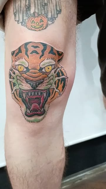 Color tattoo of a roaring tiger head